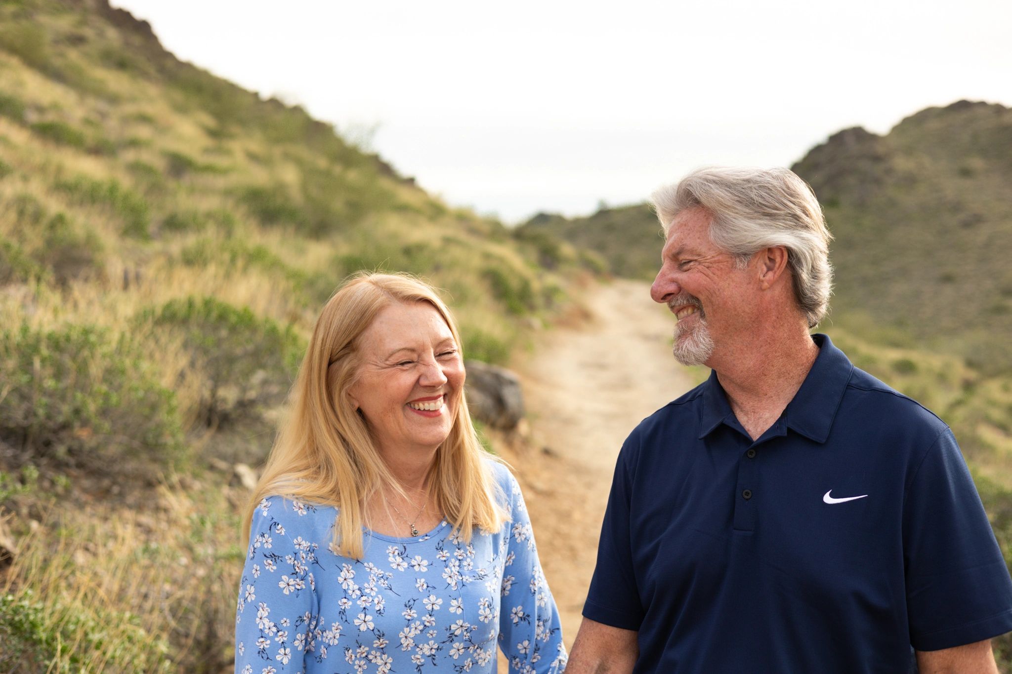 Couple smiling at each other on canyon trail